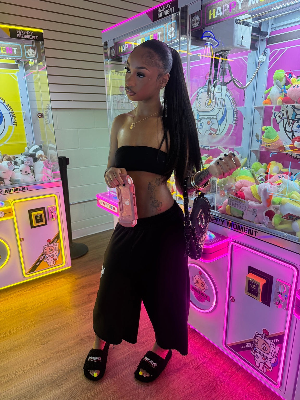 Black Spotted One long shorts styled at an arcade