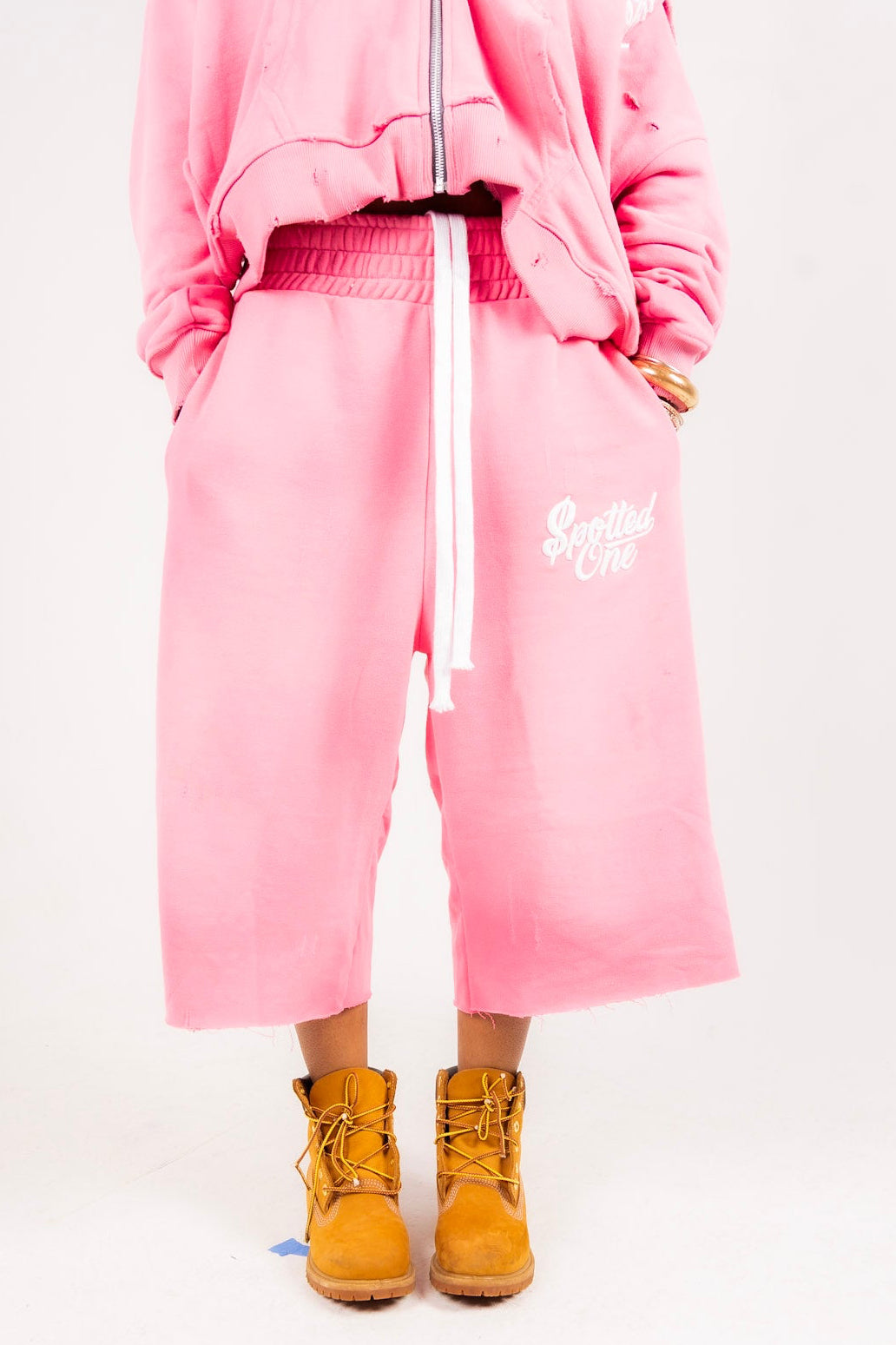 Pink Spotted One long shorts styled on body; zip-up sold separately