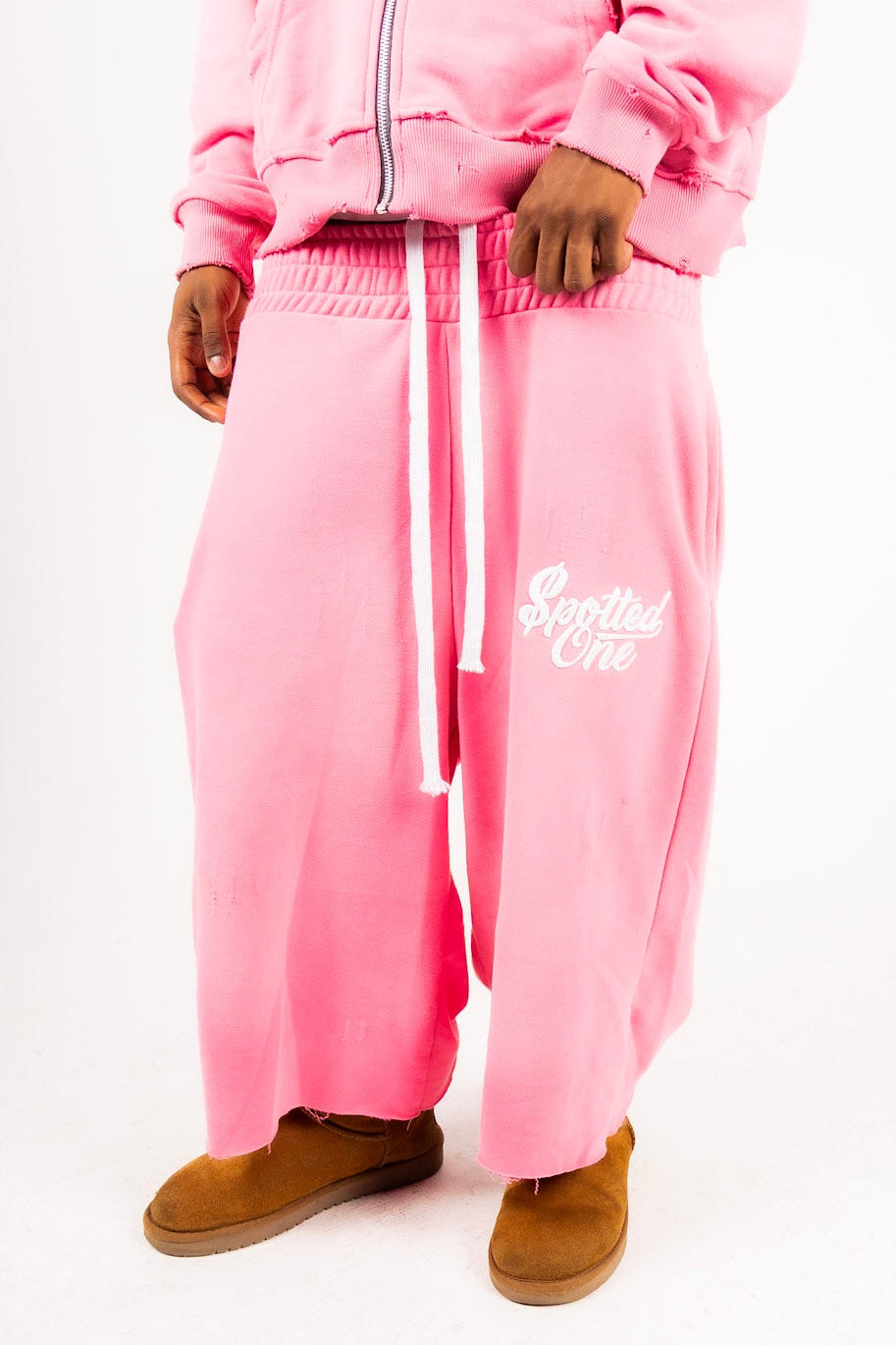 Pink Spotted One long shorts styled on body; zip-up sold separately